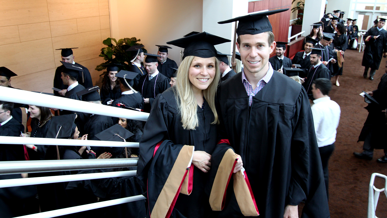 Nicole and Robert Panor with their graduate hoods prior to lining up for the Jenkins MBA Hooding Ceremony.
