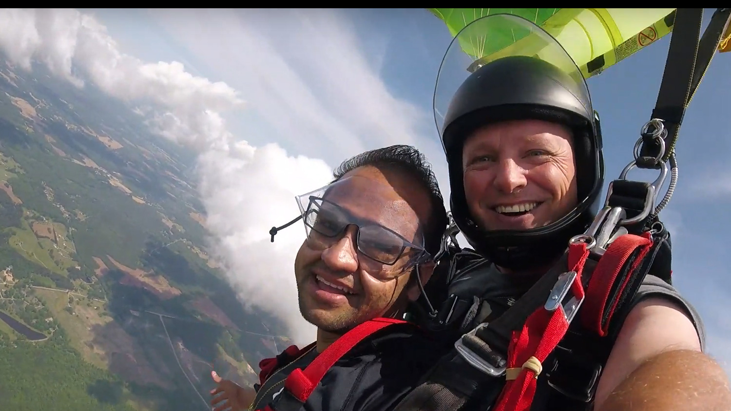 Sahir Patel, in the air with his Triangle Skydiving tandem partner
