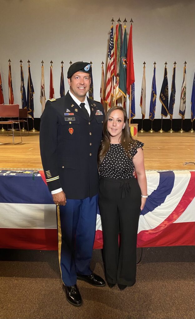 Luke Hale standing with his significant other while dressed in military uniform.