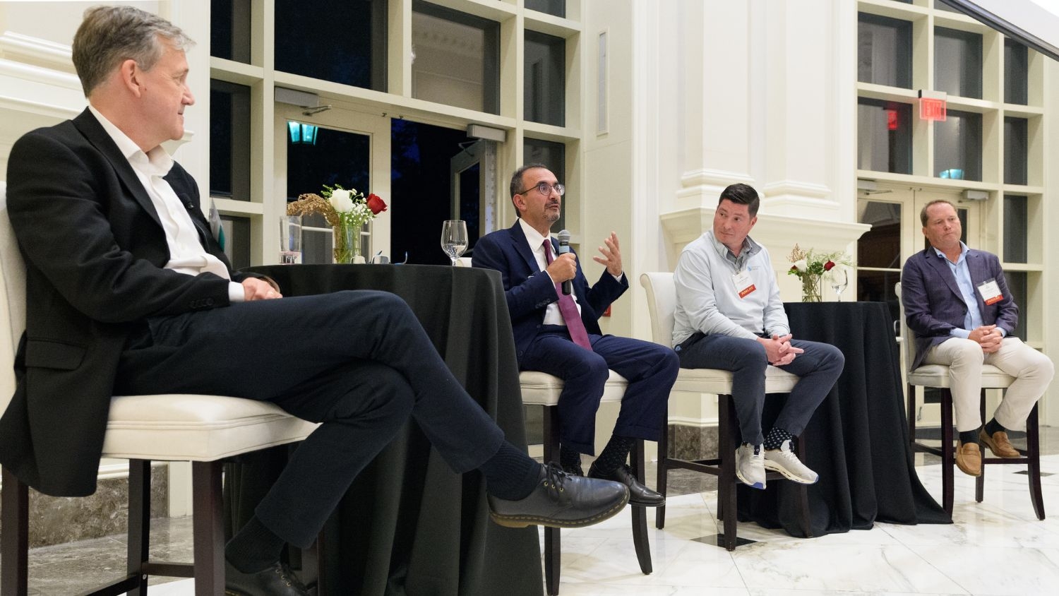 Richard Warr, Amir Mehr, Timothy McLoughlin and Jennings Glenn are participating in a panel discussion.