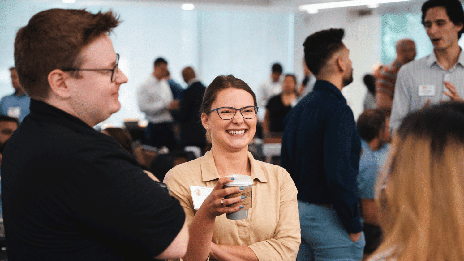 Jenkins MBA alum holds a cup of coffee and laughs.